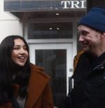 A woman and a man with sight loss laughing together.